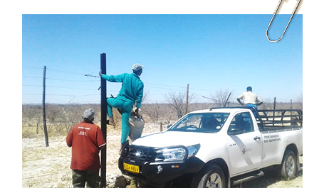 IRDNC’s Human-Wildlife Support Unit with farmers fixing the Etosha National Park’s fence after retrieving cattle that entered the Park prior